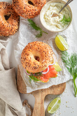 Homemade bagel with salmon, onion and avocado for fresh lunch