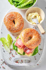Tasty bagel with prosciutto and cheese for fresh breakfast