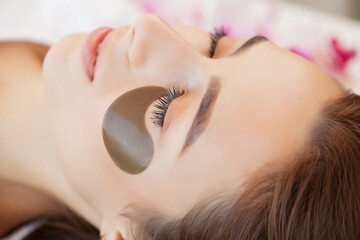 Fototapeta premium Spa treatment, beautiful woman with facial eye patch at beauty salon.