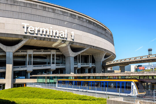 Roissy-en-France, France - July 27, 2020: A CDGVAL airport shuttle is stationing at the terminus station at the foot of the Terminal 1 circular concrete building of Paris-Charles de Gaulle Airport.