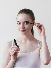 Mascara woman portrait, beautiful brunette model applying brush mascars eyes lashes