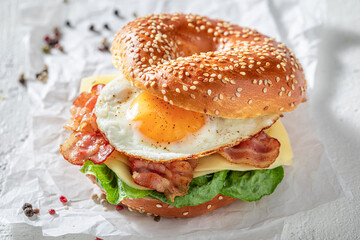 Tasty bagel with egg and bacon for breakfast