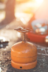 Orange camp gas canister on the ground