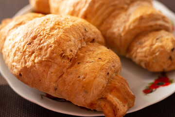 two whole grain croissants on a plate