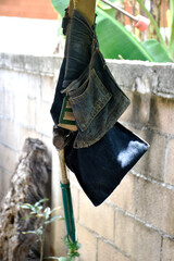 A pocket for carpentry tools and hammers, hung next to the fence wall.