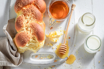 Fresh challah with honey and milk in the morning