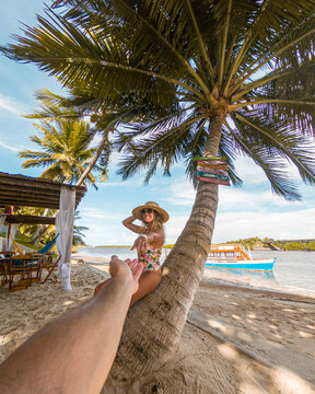 Young woman drinking coconut water in S&atilde;o Miguel, Alagoas - Brazil