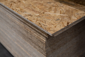 OSB sheets are stacked in a hardware store. Building material wood