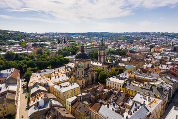 Obraz premium Aerial view of historical old city district of Lviv, Ukraine. Churches, cathedrals, city hall and houses roofs in old lviv.