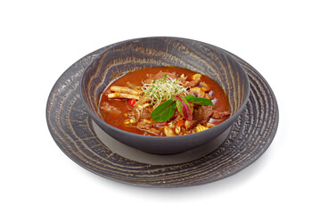 Goulash soup in bowl isolated on white