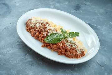 Homemade Italian pasta - spaghetti bolognese with red sauce and minced meat in a white plate