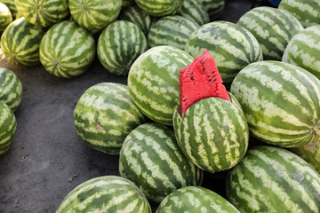 Many big sweet green watermelons and one cut watermelon. Young green watermelons. Watermelons pattern.