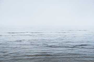 Sandy shore of the Baltic sea in a thick white morning fog. Crystal clear water, natural pattern....