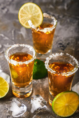 Appetizing tequila with lime and salt in a glass with ice