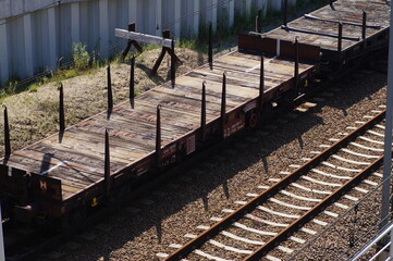 The composition of the railway wagon - platforms for large objects. An old-type platform. A metal...