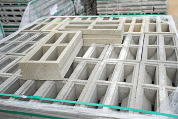 Construction concept, brick blocks on pallets in the warehouse.