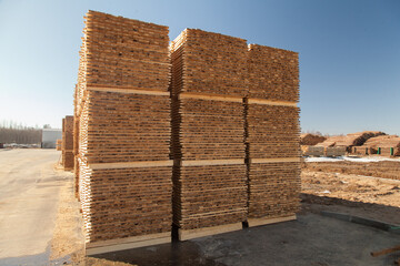 A pallet of boards in an industrial sawmill warehouse