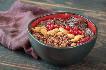 Bowl of red quinoa with nuts and sun-dried tomatoes