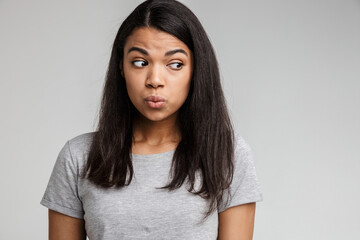 Fototapeta premium Confused young african lady dressed in casual clothes