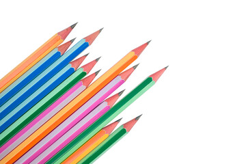 Fototapeta premium Some wood pencil crayons of different colors arranged in a wonderful line on a paper