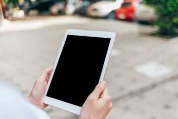 Woman holding digital tablet in her hands