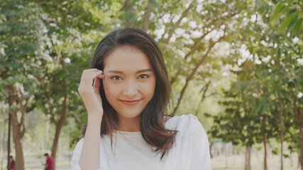 Naklejka premium Authentic close up Happy pretty asian woman. Enjoy the nature in garden for summer. End of quarantine and return to Travel around the world