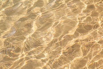 Fototapeta na wymiar Sandy bottom under a layer of water texture background