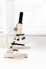 microscope instrument near to the window in the lab