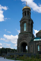 Fototapeta premium panoramic view of a dark temple with golden domes against a background of gray clouds