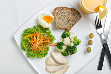 Healthy diet meal with boiled chicken meat, broccoli and vegetables salad