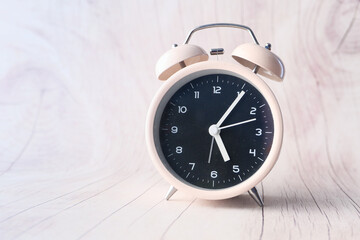 old alarm clock on wooden background.