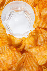 Glass cup and a bunch of chips close up