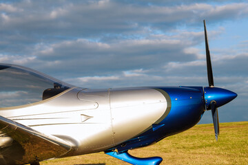 Blur. Cockpit and propeller of a small 2-seater aircraft close up.