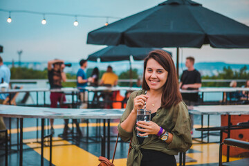 stylish fashion woman holding drink glass at cozy comfy cafe