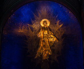 bright frescoes and symbolic objects of a religious nature on the wall in the temple