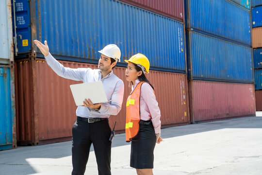 Manager and contenner worker working in the construction container yard,Industrial container yard for import and export for business concept.