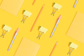 School supplies pattern on a yellow background. Monochrome creative layout.