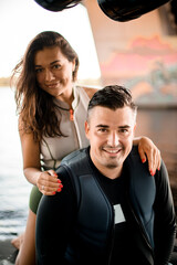 smiling couple of young woman and man in swimsuits on blurred background