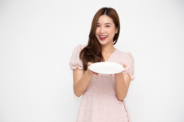 Young Asian woman holding empty white plate or dish isolated on white background