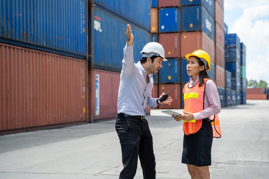 Manager and contenner worker working in the construction container yard,Industrial container yard for import and export for business concept.