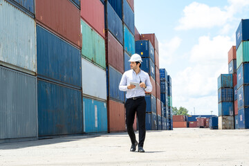 Portrait of mid adult businessman working at cargo container,Business logistic concept.