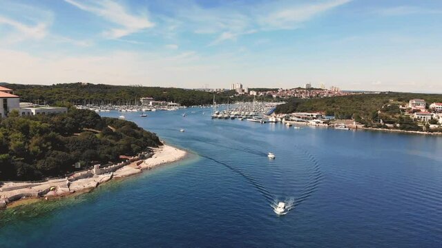 Aerial View of Scenic Pjescana Uvala Bay, Istria, Croatia. Boats in Adriatic Sea Marina and Small Town on Coast Under Summer Sun, Drone Shot