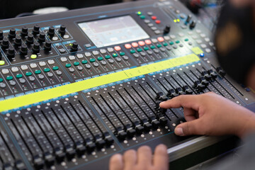 Sound recording studio mixing desk with engineer or music producer  with side view selective focus.