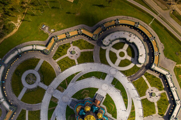 dark color temple with golden domes with geometric park from drone height
