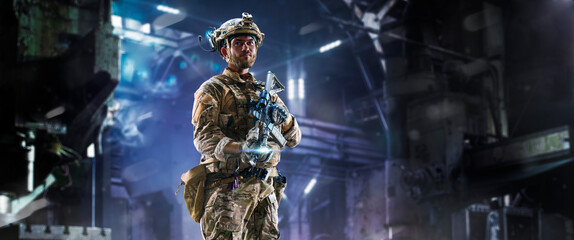 Army soldier in Protective Combat Uniform holding Special Operations Forces Combat Assault Rifle on...