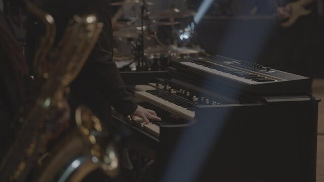 Pianist and saxophonist playing instruments in studio performance 