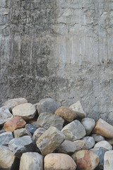 Stone background - stones near the concrete wall.