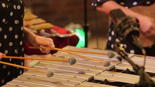 Female band playing xylophone and guitar in festive holiday performance