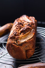 Food Dessert concept fresh baked organic rustic Banana bread on black slate stone board