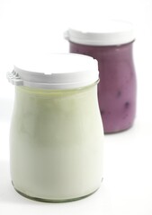 Glasses of Natural and Raspberry Yoghurt against White Background